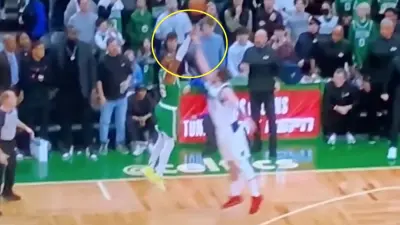 Luka Doncic tries to block a Marcus Smart shot