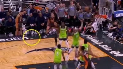 Jalen Suggs kicks a water bottle
