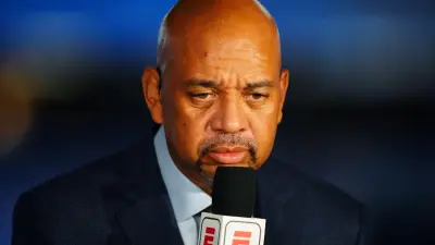 Michael Wilbon holds a mic