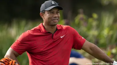 Tiger Woods stands with a club