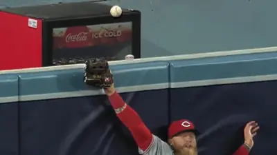 Jake Fraley jumps against the wall