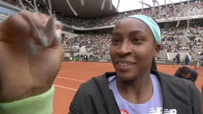 Coco Gauff writes on a camera lens