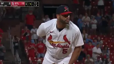 Albert Pujols leans in on the mound