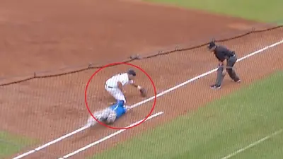 A play at first base between Auburn and Kentucky
