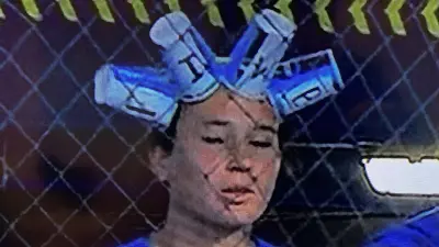 A UCLA player with cups on her head
