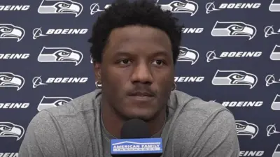 Chris Carson at a press conference