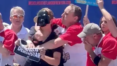 Joey Chestnut puts a protestor in a chokehold
