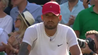 Nick Kyrgios wears a red hat