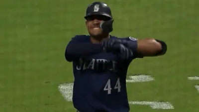 Julio Rodriguez grabs his wrist