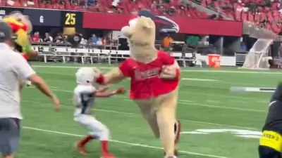 Braves mascot Blooper stiffarms a kid