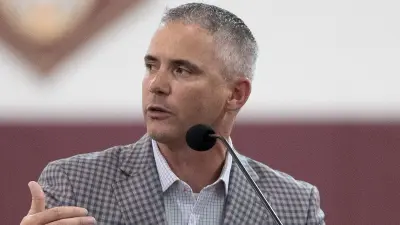 Mike Norvell looking away.