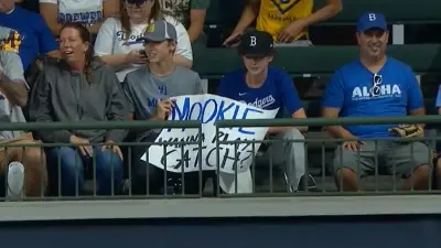 Fan holds a Mookie Betts sign