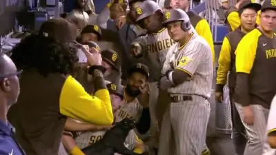 The Padres posing in the dugout with a panther