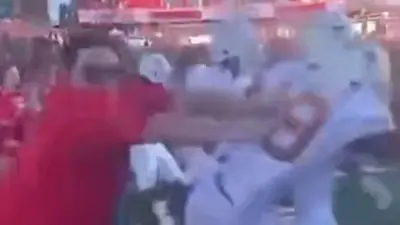A Texas Tech fan pushes a Texas player
