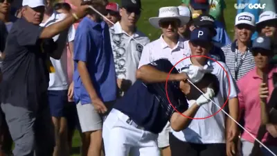 Bryson DeChambeau walks into a rope