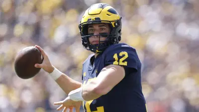 Cade McNamara throwing a pass