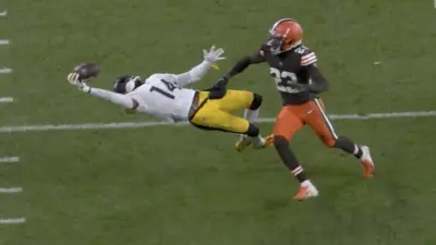George Pickens reaches for a ball