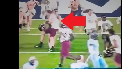 A Virginia Tech player nails a student