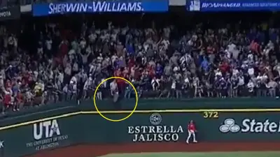 A fan jumps over a barricade