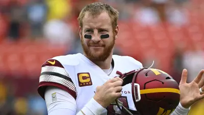 Carson Wentz holding his helmet