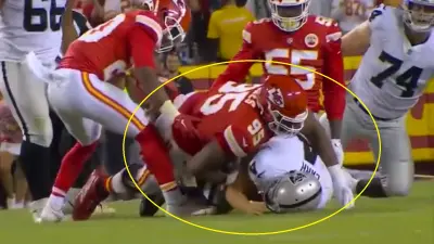 Chris Jones lays on Derek Carr