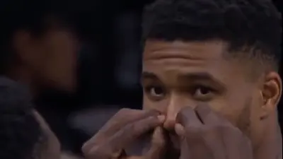 Giannis Antetokounmpo getting his nose held