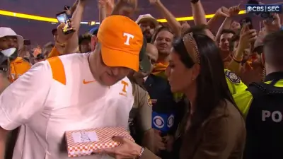 Jenny Dell hands Josh Heupel cigars