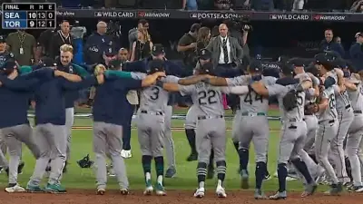 The Seattle Mariners celebrating in a circle