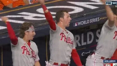 Phillies players celebrating in the dugout