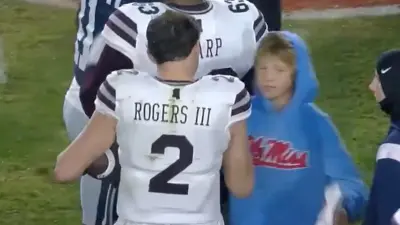 Will Rogers gives Lane Kiffin's son a souvenir