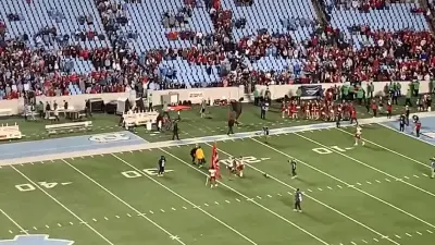 NC State players hold a flag