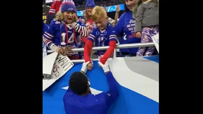 Stefon Diggs holds a fans hands