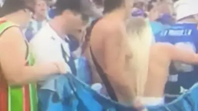 An Argentina fan celebrates topless