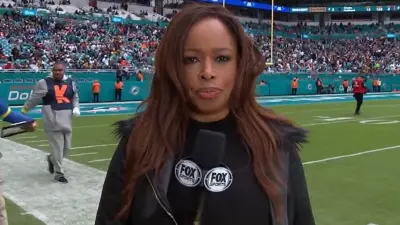 Pam Oliver holding a mic