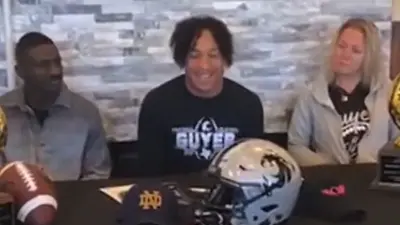 Peyton Bowen with hats in front of him