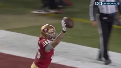 George Kittle holds the ball