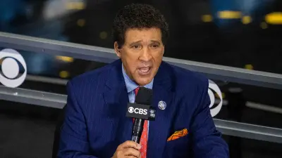 Greg Gumbel holding a microphone