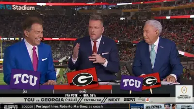 Nick Saban smiles next to Pat McAfee