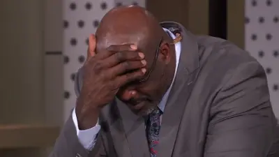 Shaq covering his forehead