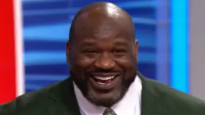 Shaq smiling with a weird haircut