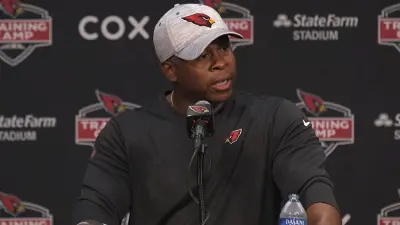 Vance Joseph at a podium