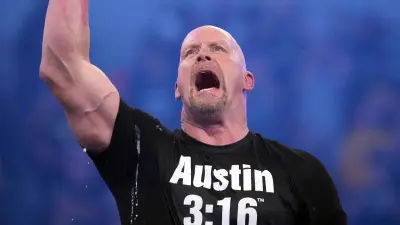 Steve Austin holds up a beer