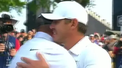Brooks Koepka hugs Mike Block