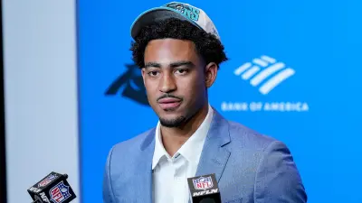 Bryce Young wearing a Panthers hat