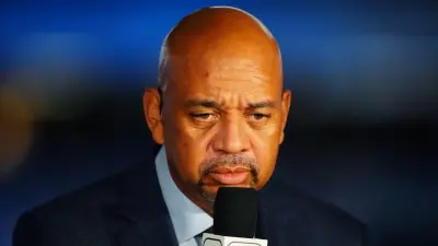 Michael Wilbon holding a microphone