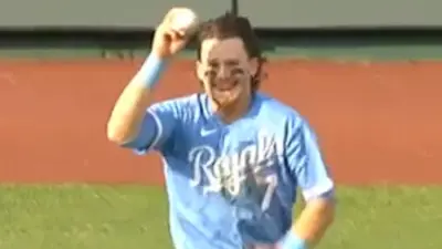 Bobby Witt Jr holds up a ball