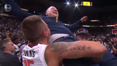 Michael Malone being lifted by the Jokic brothers
