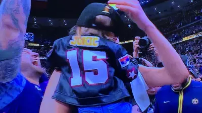 Nikola Jokic holds his daughter