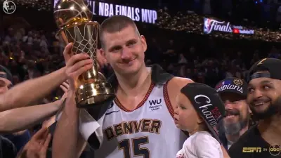 Nikola Jokic holds up the trophy