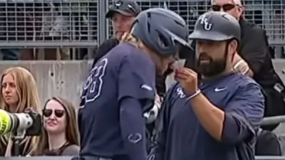 An Oral Roberts coach feeding a player